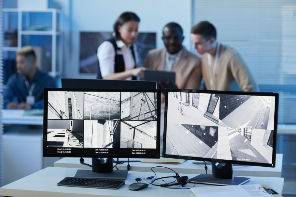 Background image two computer screens with surveillance camera feed