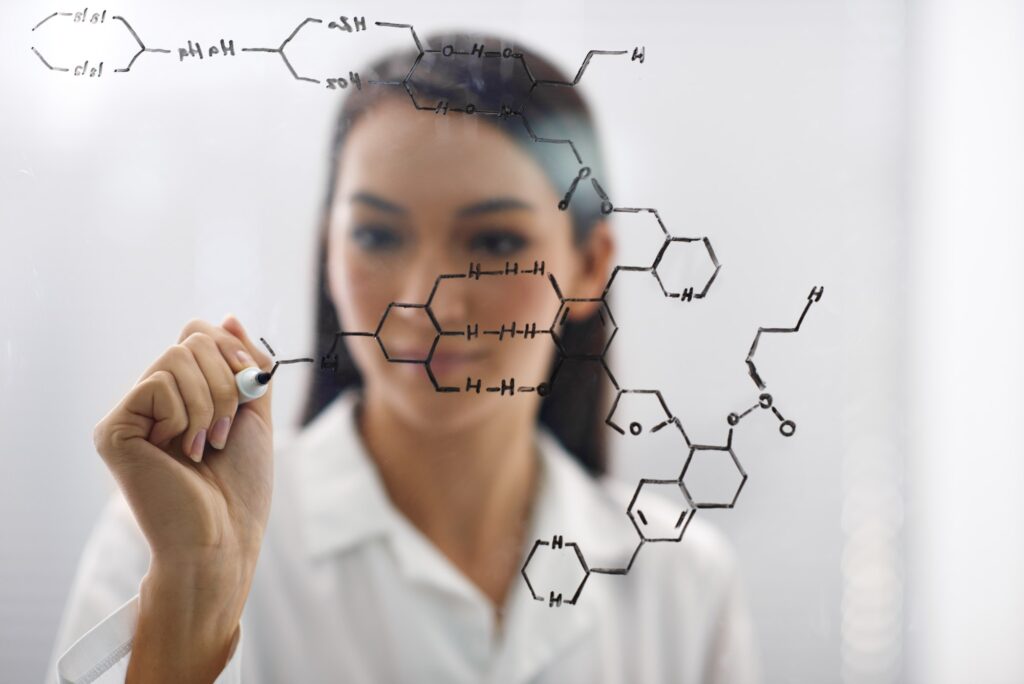 Marvels of mankinds genius. Cropped shot of a female scientist drawing up a molecule.