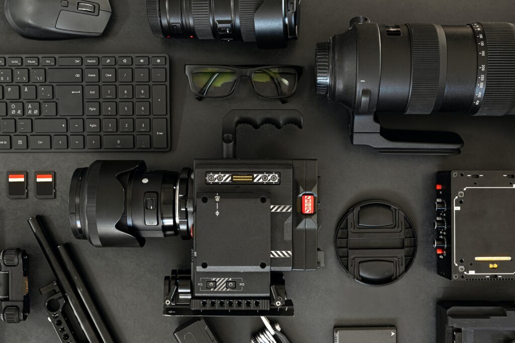 Top View of a Creative Filmmakers Office Desk with Lined up Camera and Gear