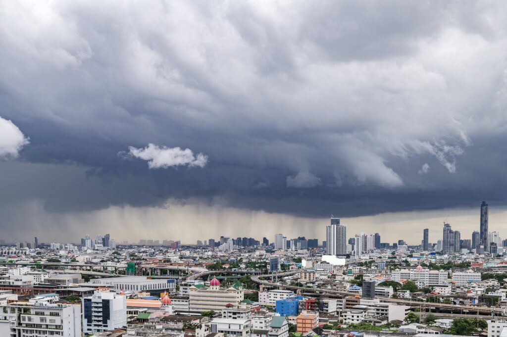 A heavy storm with rain and dramatic atmosphere clouds can be a sight to behold over a city center.