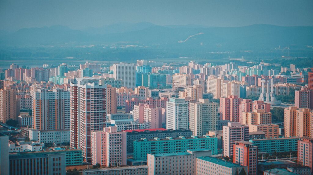 Drone view of a cityscape with skyscrapers and residential buildings in North Korea