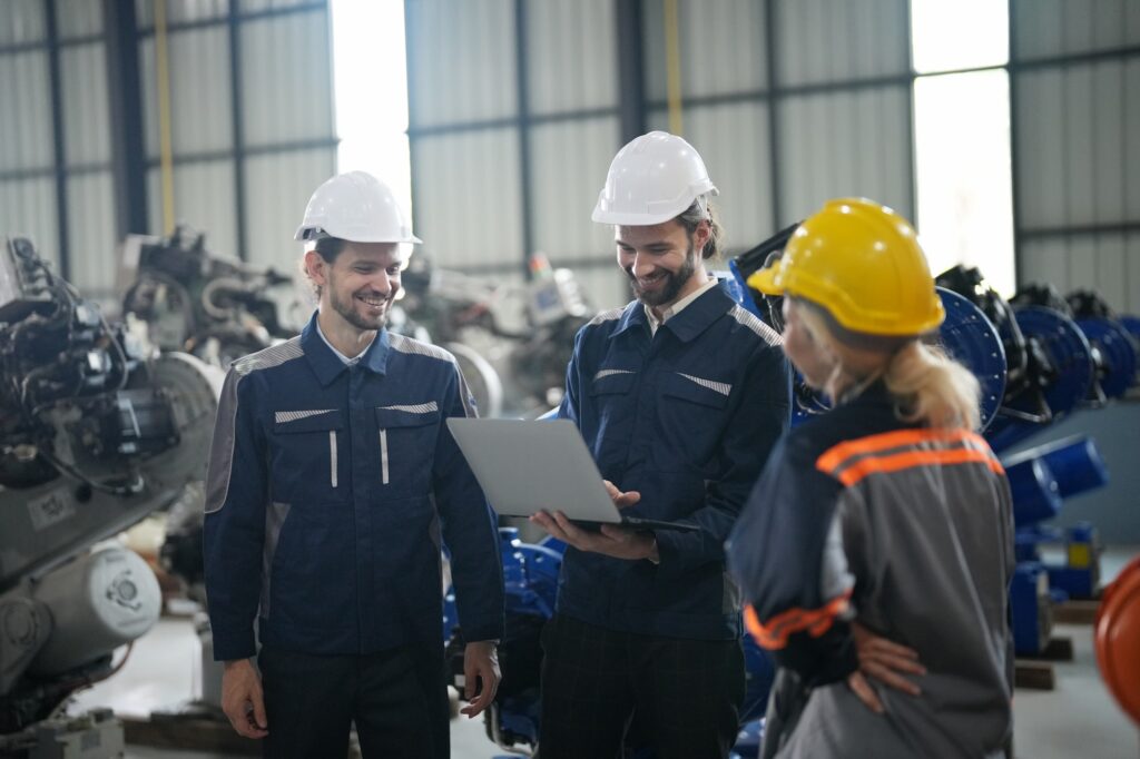 Engineer inspecting automatic AI robot arm and machines in factory. Engineer inspecting automatic AI