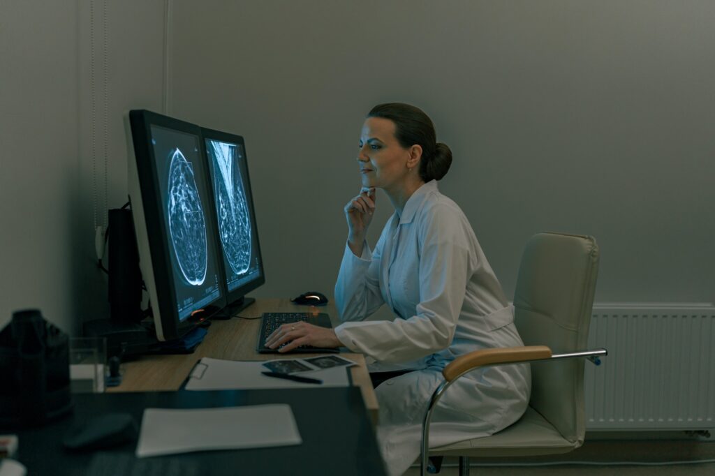 Female doctor neuroscientist analyzing brain scan MRI images in hospital