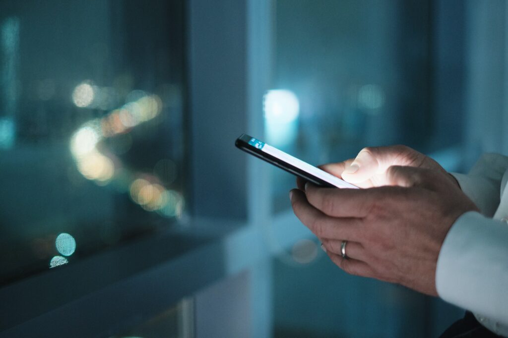 Hands Of Business Man Typing Text Message On Phone