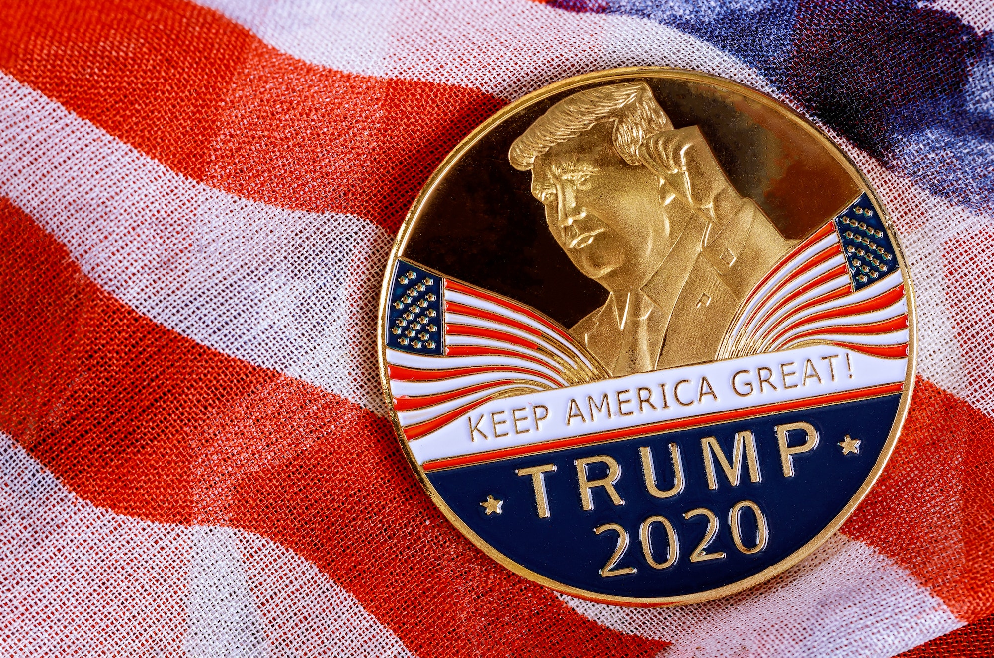 New York NY NOV 12 2019: Donald Trump coin presidential against US flag in the election 2020