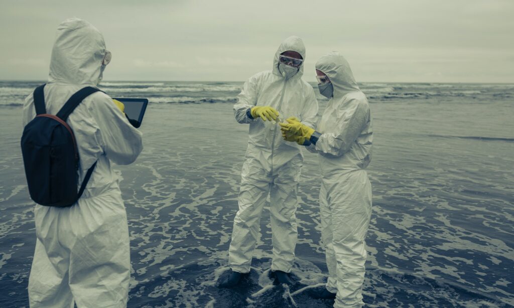 People with protection suits analyzing seawater