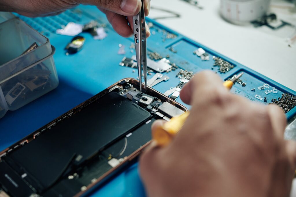 Repairman fixing smartphone camera