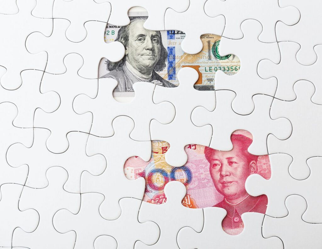 White puzzle with US and chinese banknote