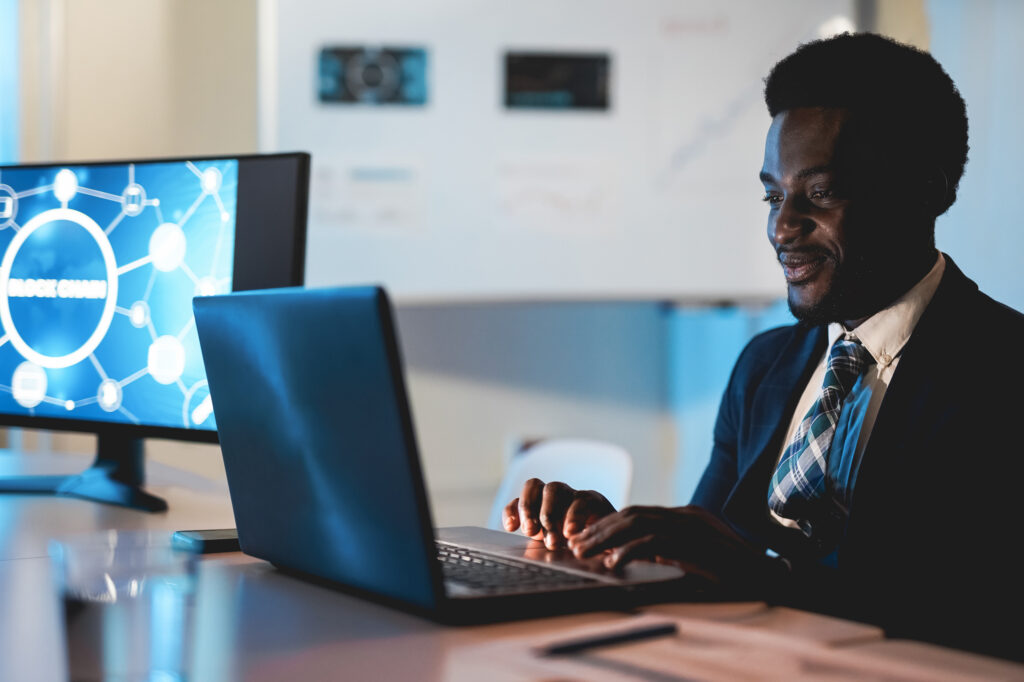 African man trader working inside hedge fund office - Focus on face