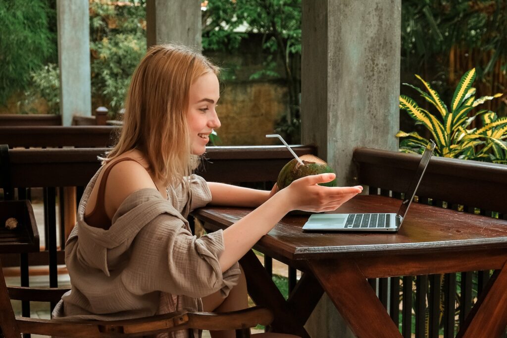 Business.woman working using laptop outdoors home garden.Remote work freelancer travel.cozy green w