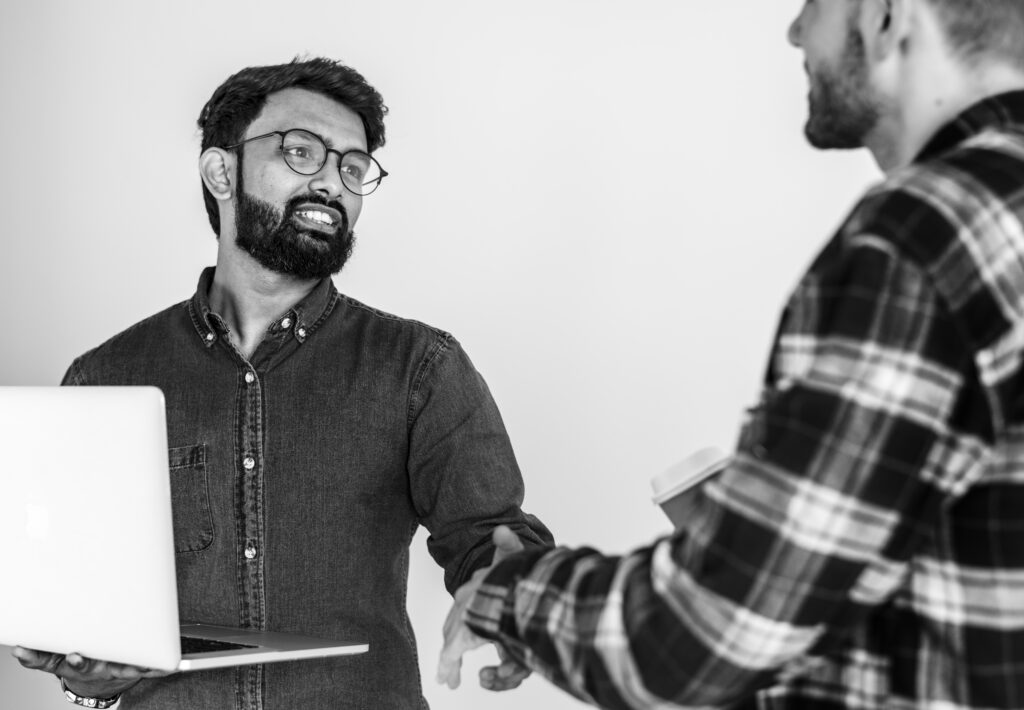 Diverse colleague men shaking hands together