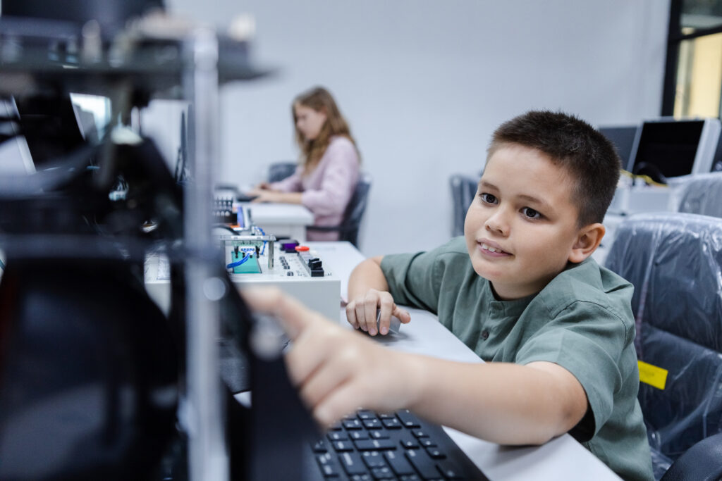 Electronic class room. Kid boy education electronic AI class and touching screen STEAM digital.