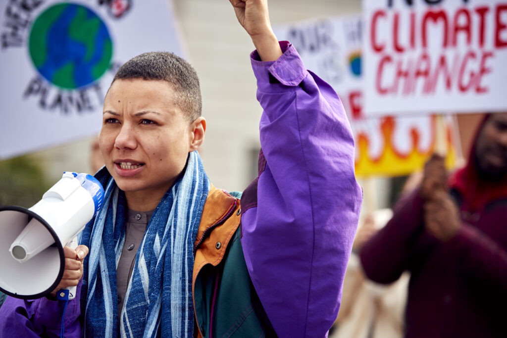 Group Of Protestors With Placards On Demonstration March Against Climate Chane