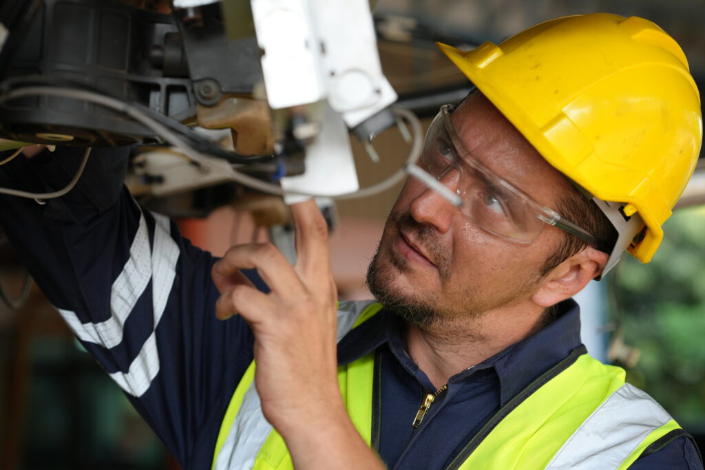 Industrial engineers working at automated AI robotic production factory - New tech industry.