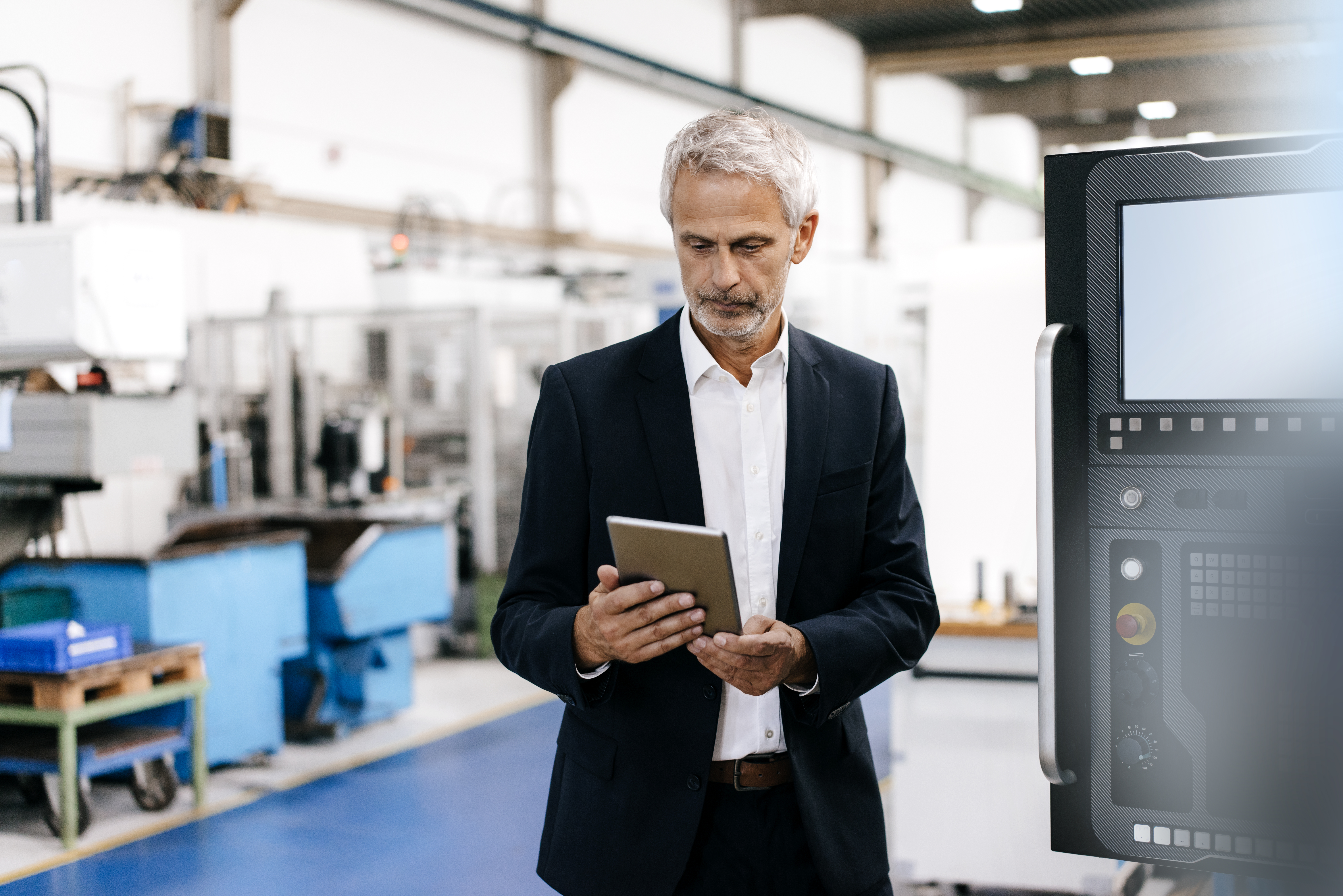 Manager using digital tablet in high tech company