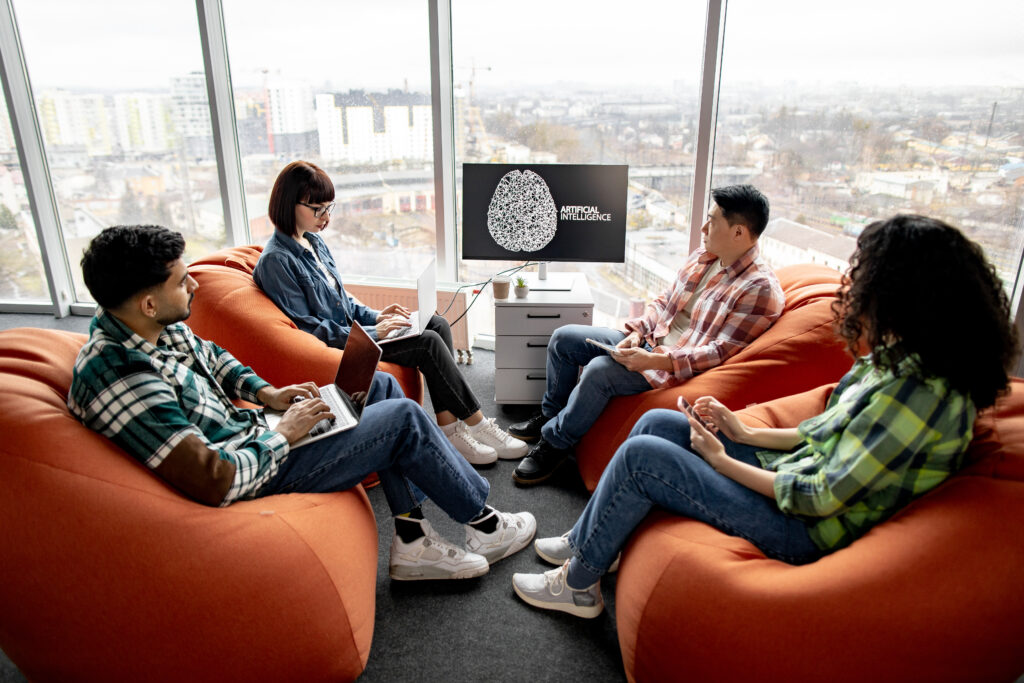 Professionals with gadgets working on AI project in office