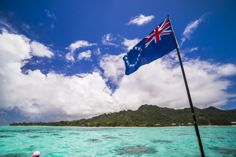 Rarotonga and the Cook Islands flag seen from Muri Lagoon, Rarotonga, Cook Islands