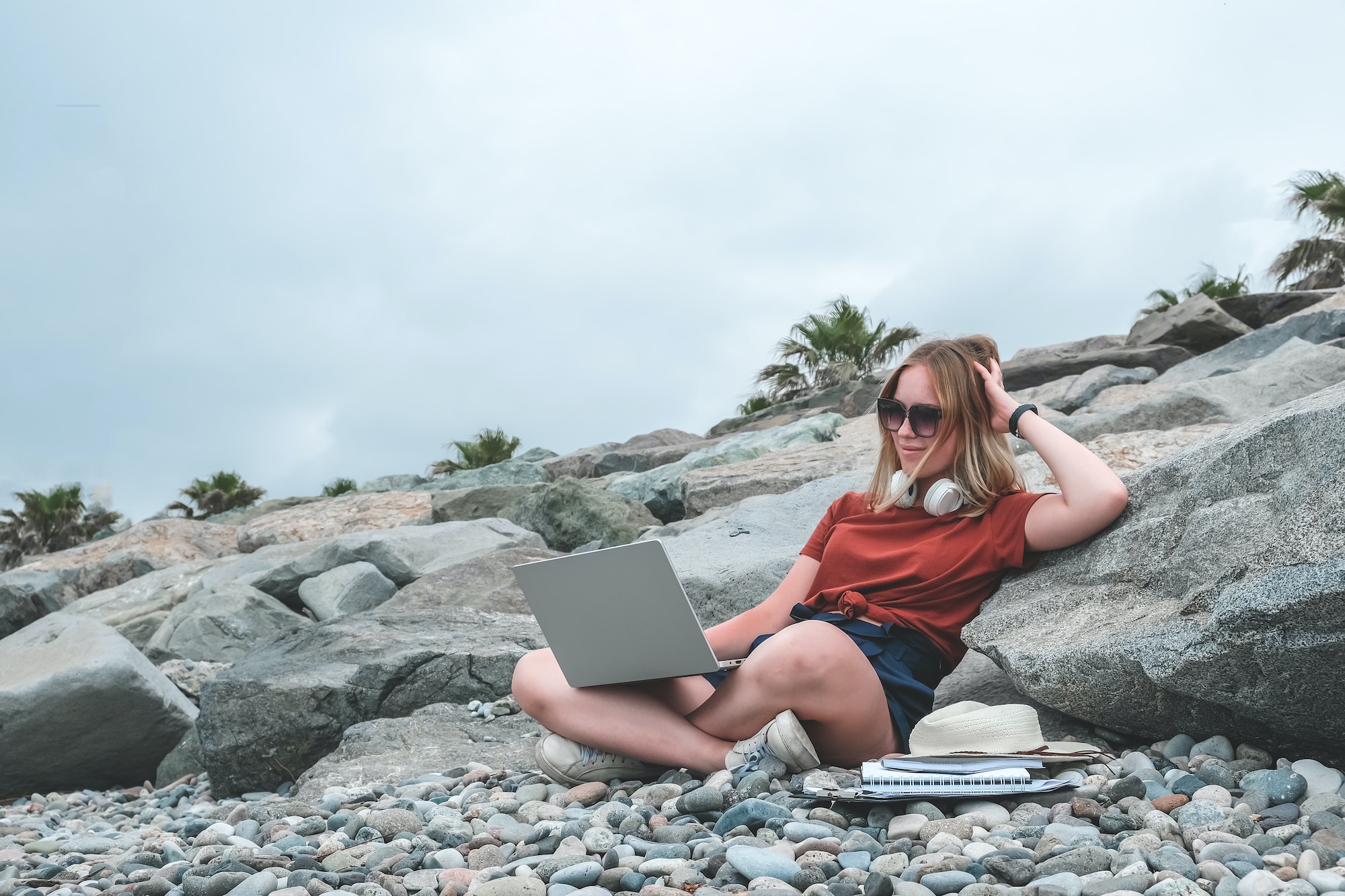 Remote work.Girl freelancer works remotely on the seashore.workation, remote work,WFVH,Van Life