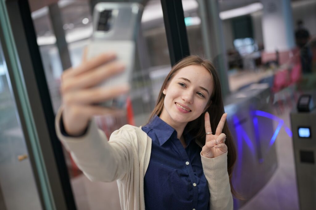 Young attractive female using a mobile phone for social media and using new online 5G technology app