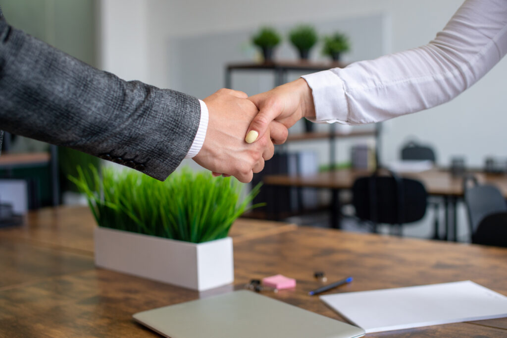 A man shakes a woman's hand, gender equality