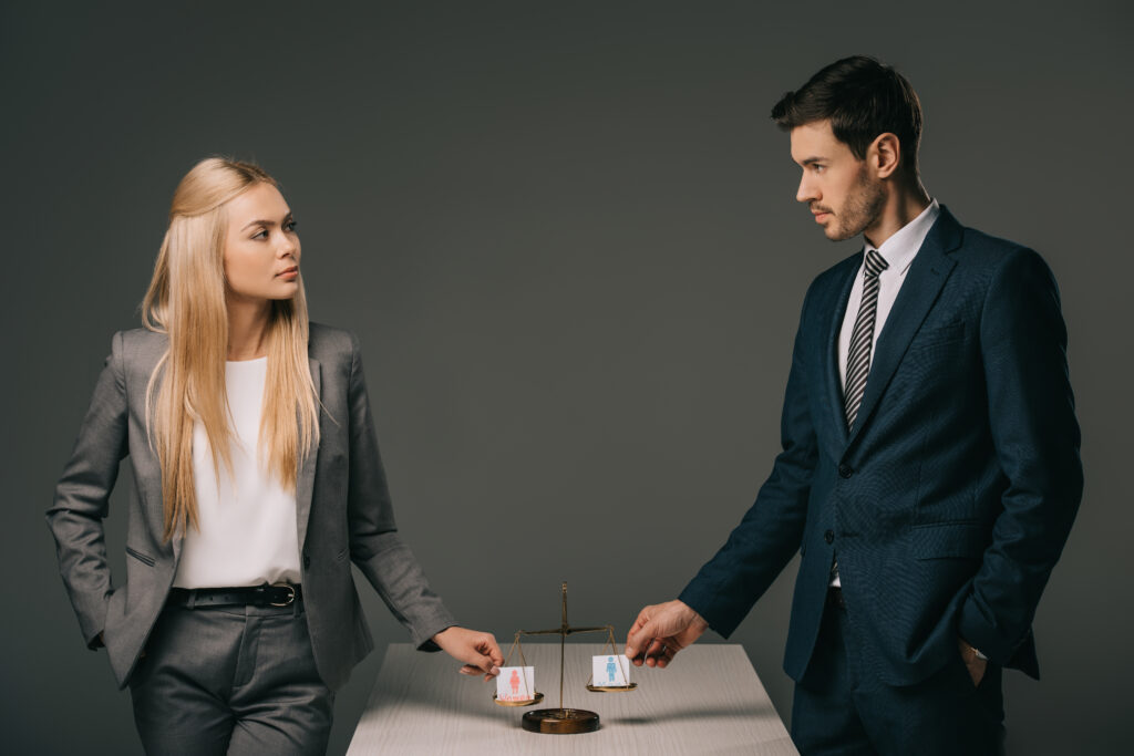 business colleagues with male and female signs on scales of justice, gender equality concept