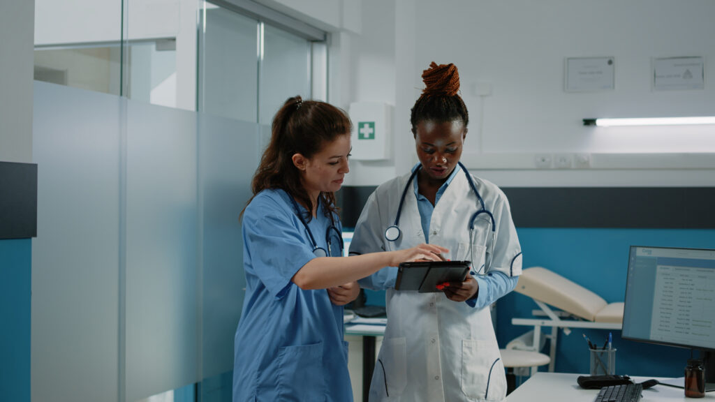 Doctor and nurse working with tablet for healthcare system