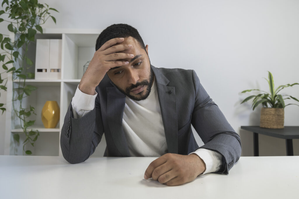 Frustrated black latino businessman, CEO in a conference call. Entrepreneur overworked.