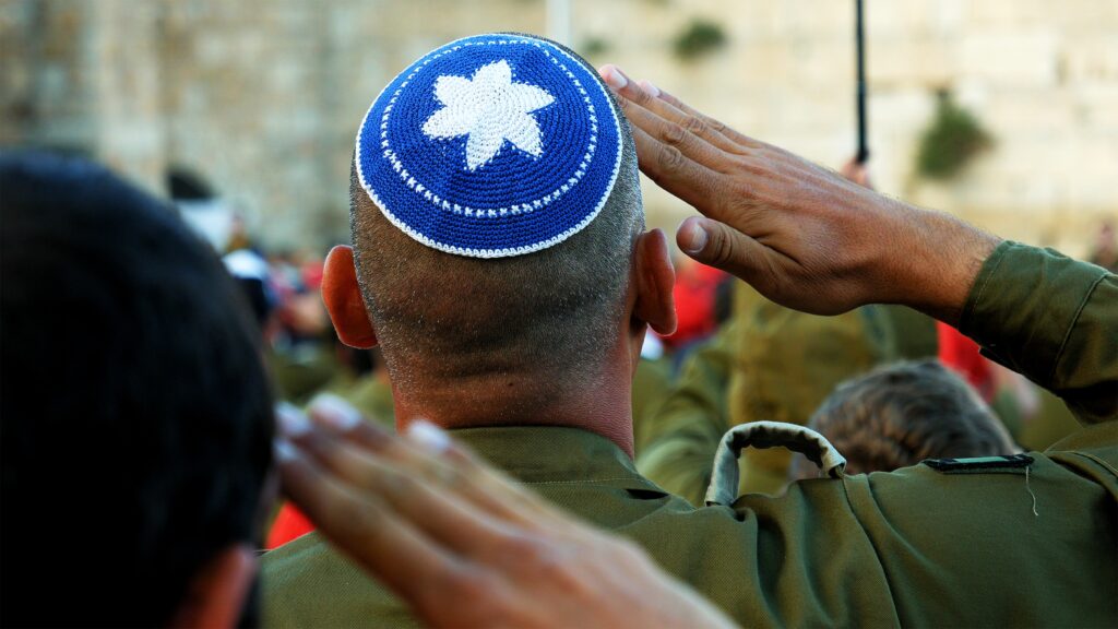 Israeli soldier military man saluting to the Western wall in Jerusalem