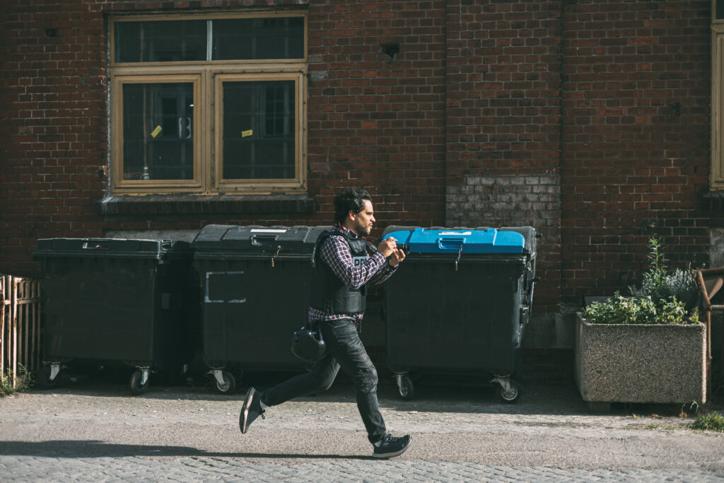 Photojournalist running with camera in hand