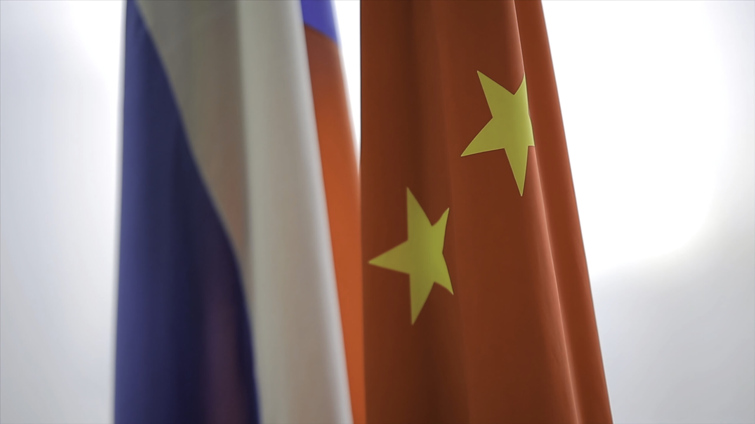 russian and chinese flags two flags of russia and china symbolizing the cooperation between the