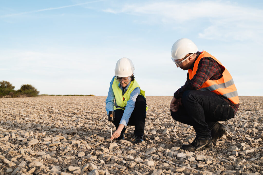 Survey engineers working at construction land site - Topographic work concept - Focus on woman face