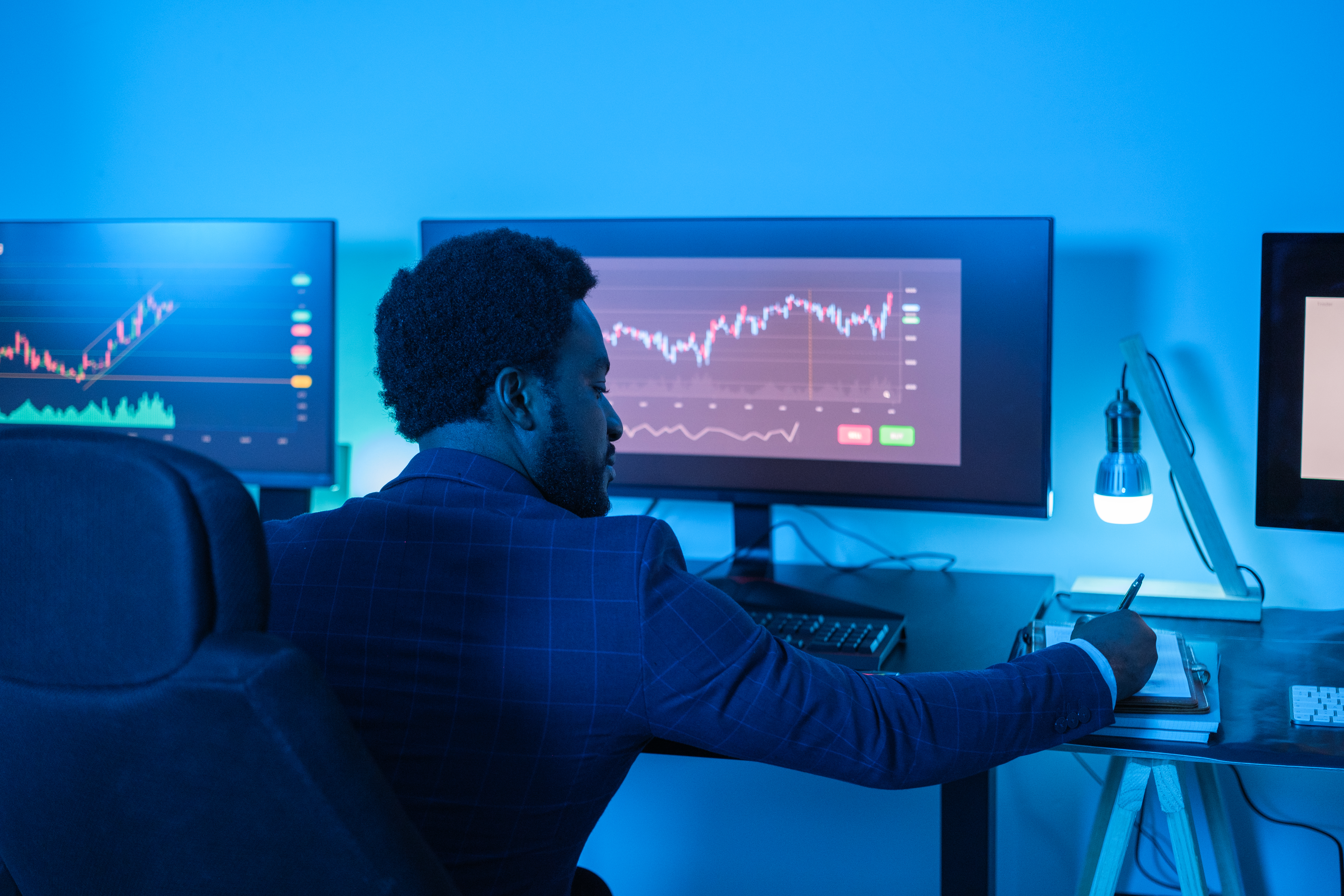 Young man in suit studying the market and making investments. Concept: Finance, business, investment