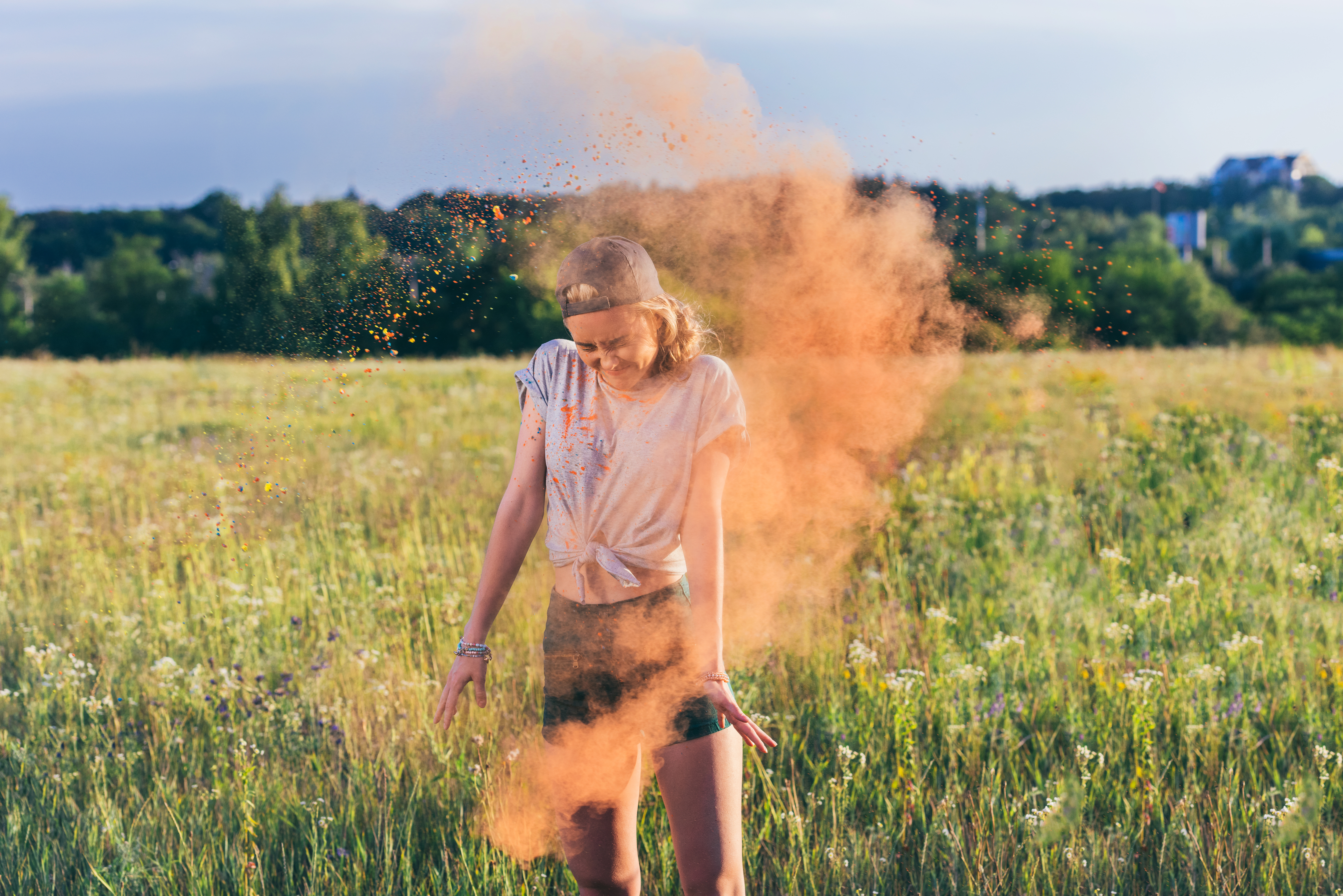 young woman throwing colorful powder during holi festival