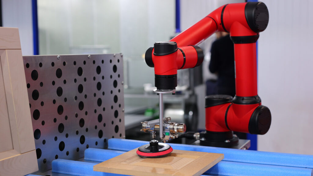 An automated robotic arm polishing a wooden surface. High-tech industrial production.