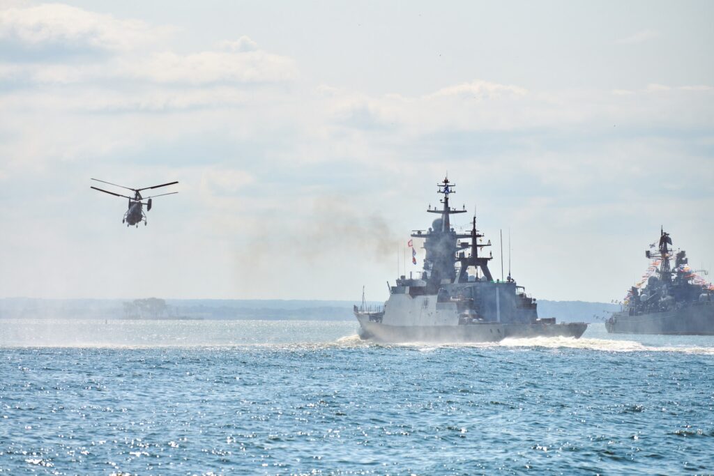 Battleships war ships corvette during naval exercises and helicopter maneuvering over sea, warships