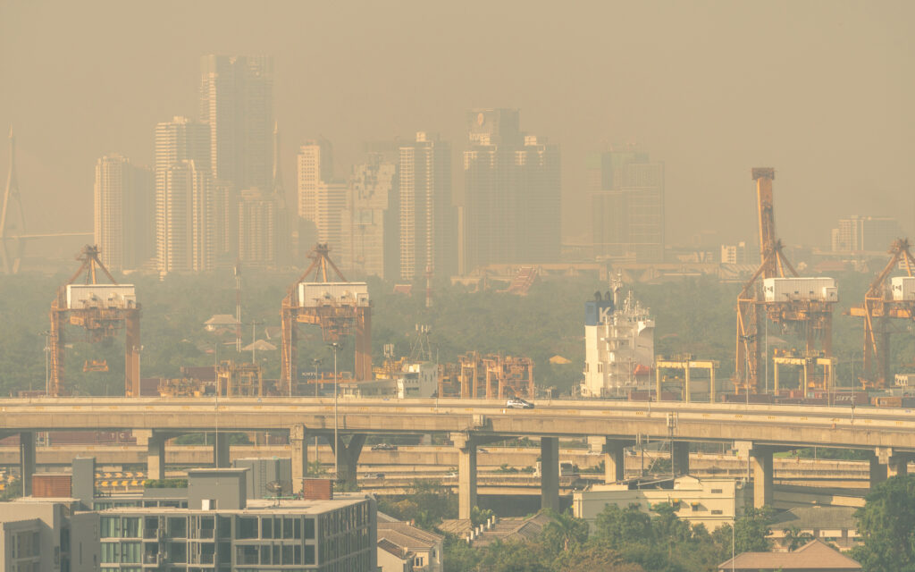 Blur photo of cityscape with polluted air. Air pollution. Smog and fine dust of pm 2.5 covered city.