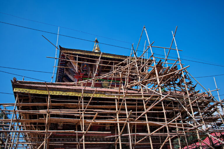 Buddhist temple under construction after earthquake with bamboo scaffolding in Kathmandu