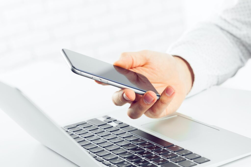 businessman is using laptop computer and smartphone