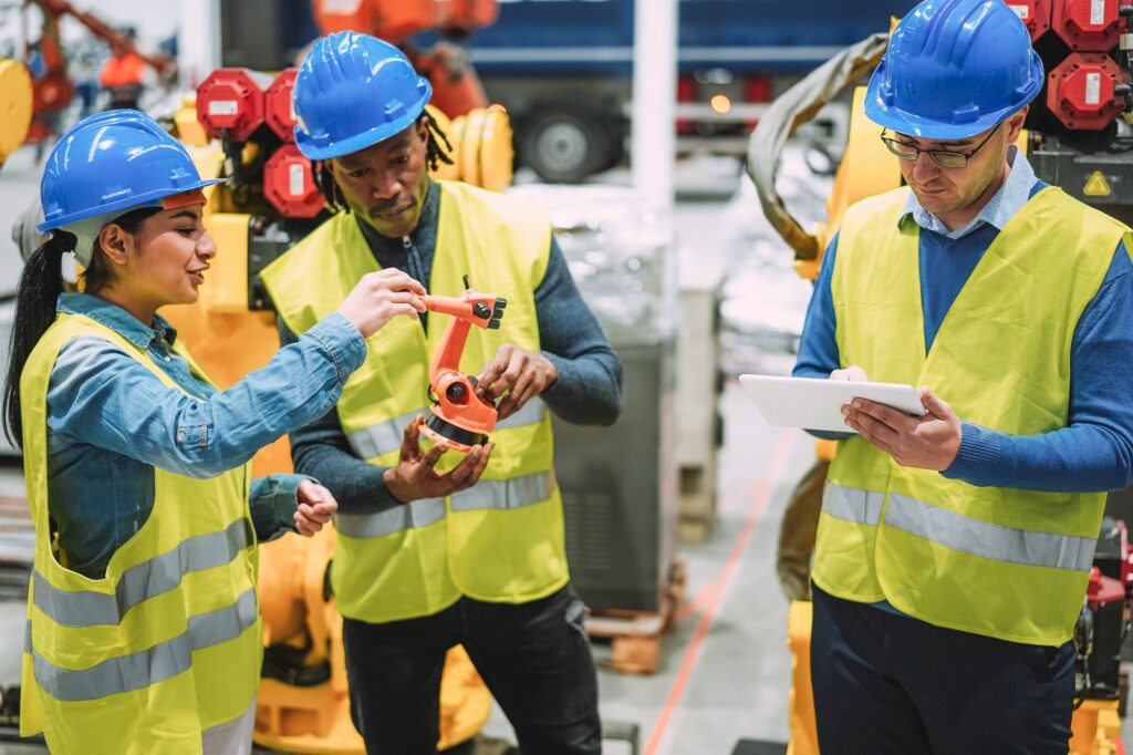 Engineers working at new AI prototype inside robotic factory