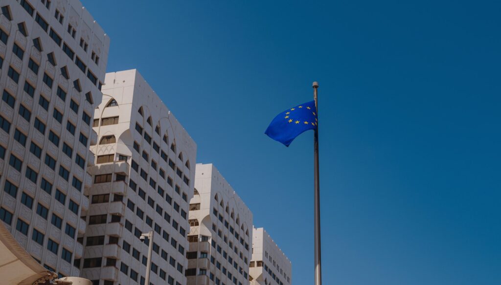 EU flag in blue sky background.