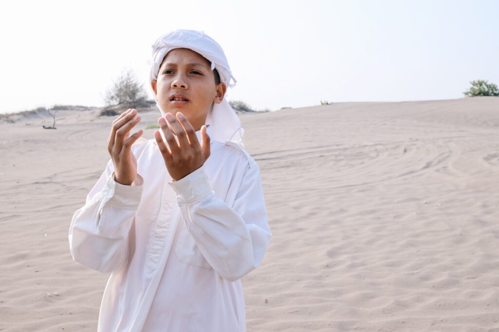 Palestine Boy Praying in Sand Dunes