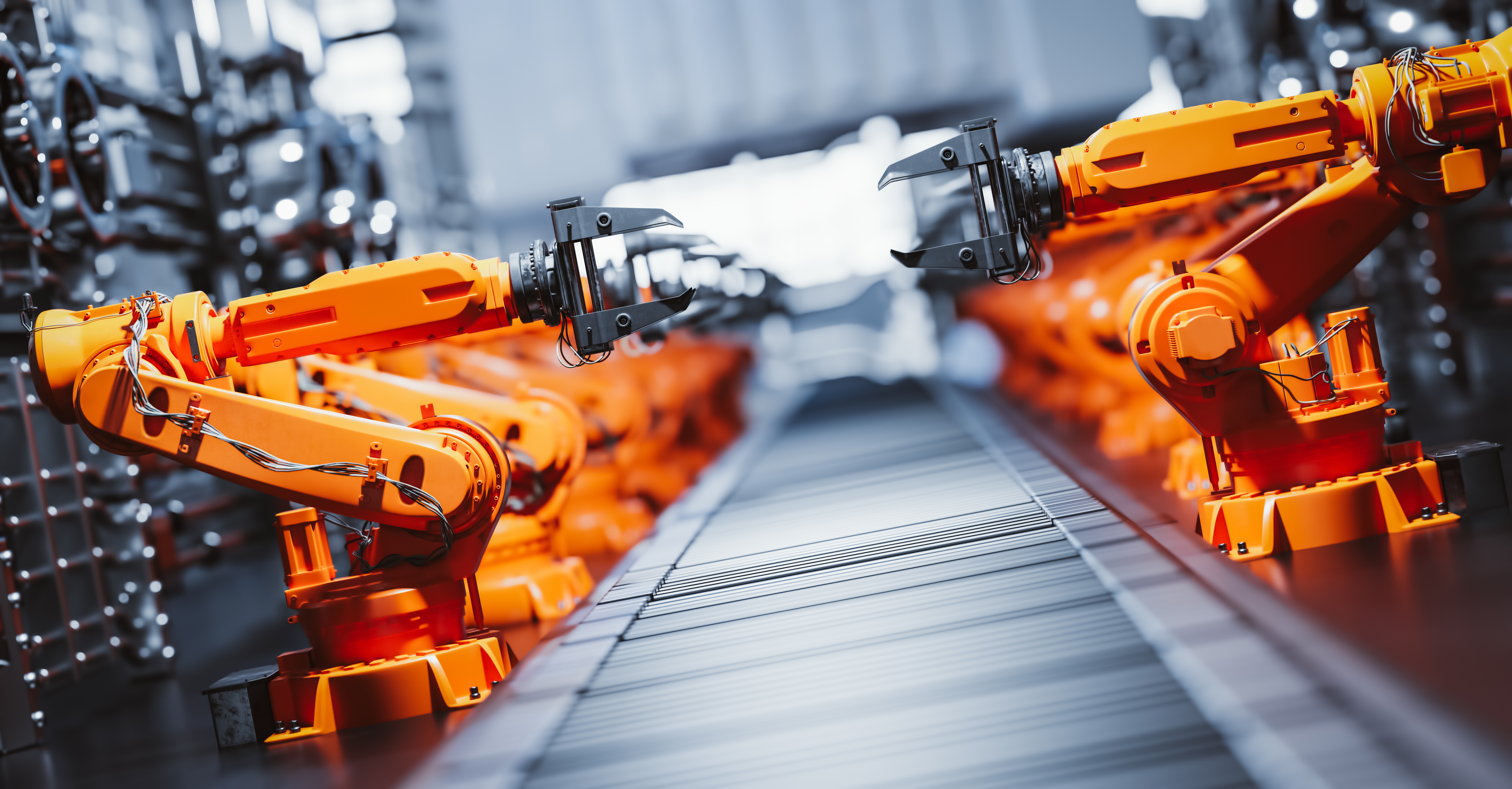 Robotic arms along assembly line in modern factory.