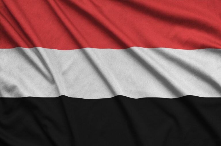 Yemen flag is depicted on a sports cloth fabric with many folds. Sport team waving banner