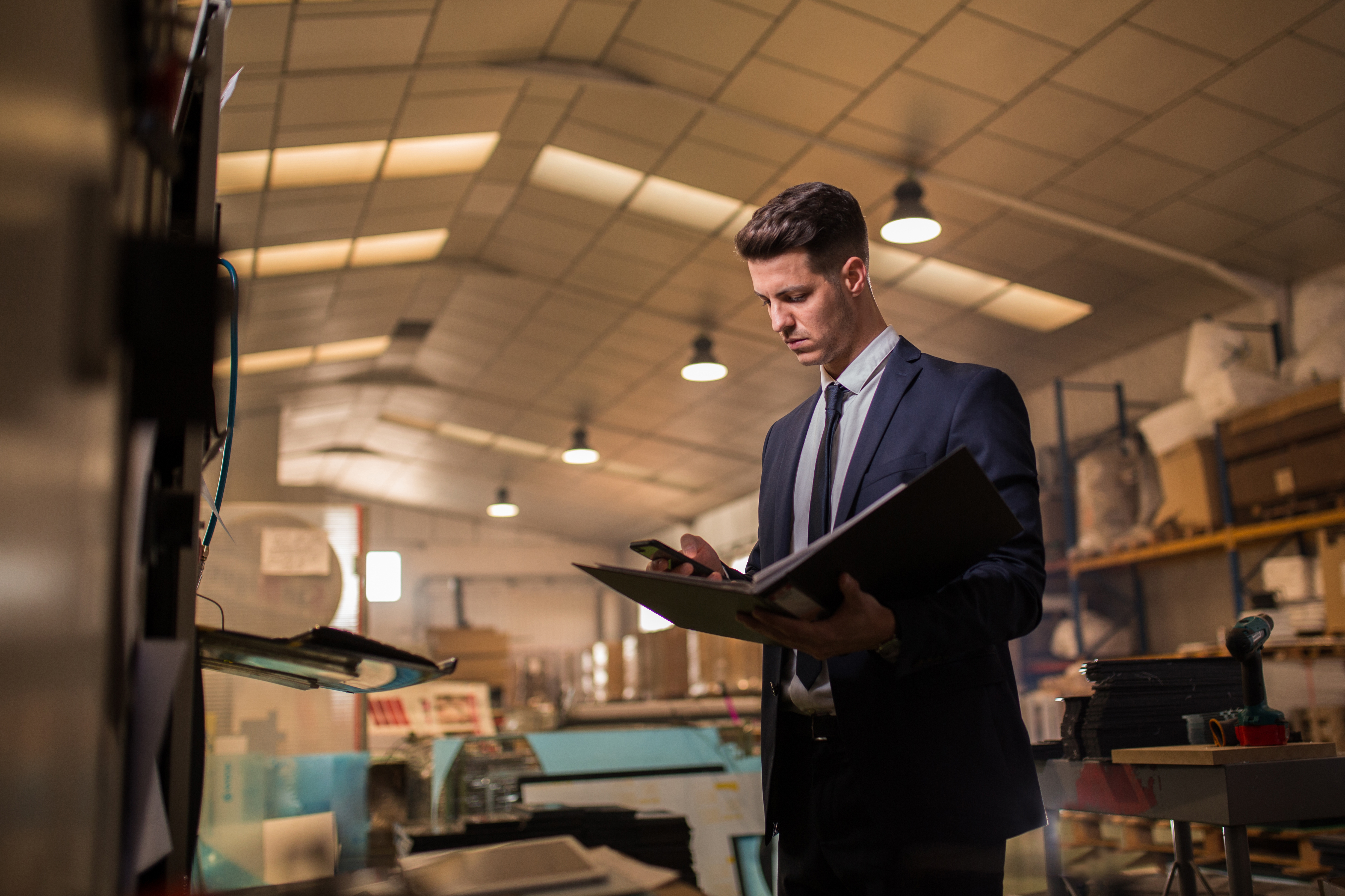 Young man in suit inspecting industrial sector