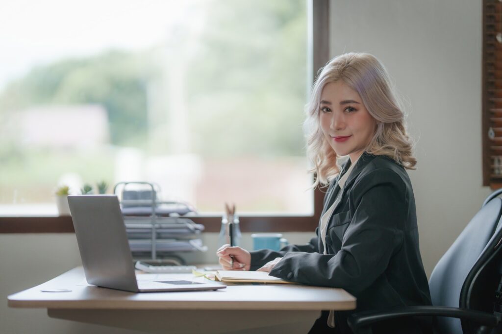 Asian Business woman working to analyze technical price graph and indicator with business team