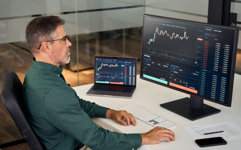 Busy mature business investor stock trader analyzing investing trading market.