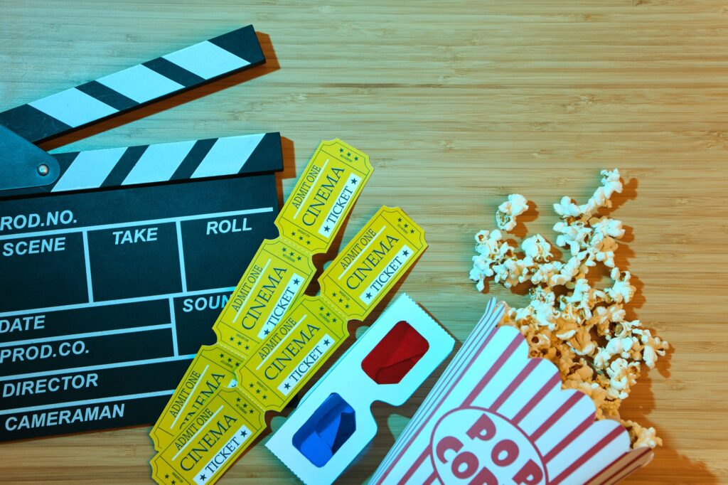 clapper board, movies tickets and popcorn.