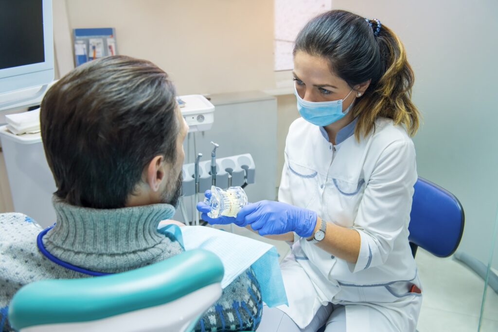 Dentist holding artificial teeth