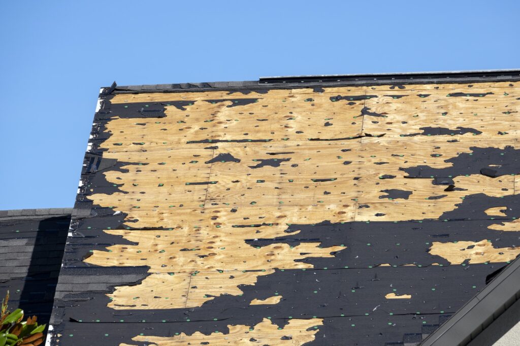 Hurricane Ian destroyed house roof in Florida residential area.