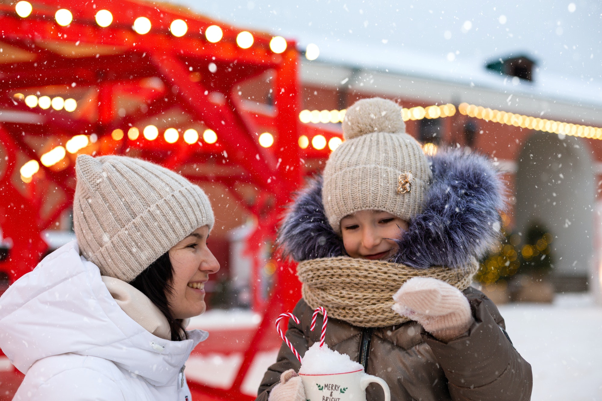 Mom and daughter for Christmas outdoor in warm clothes in winter